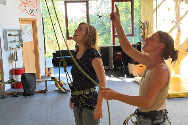 Das Bild zeigt Anne mit Andrea Sprenger vor der Kletterwand